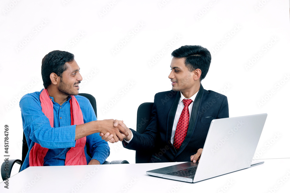 Financial adviser shaking hands with a farmer at office Financial adviser shaking hands with a farmer at office