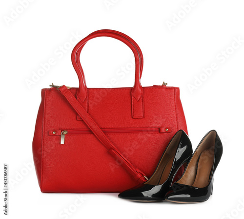Red women's bag and high heeled shoes on white background