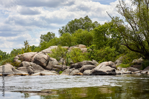 Summer landscape of fast Southern Bug river with rocks