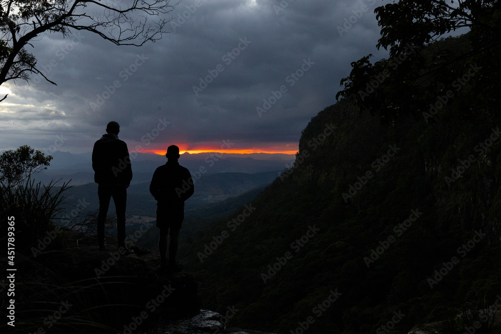 silhouette of people on a mountain top