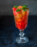 Watermelon dessert with sparkling water and mint in a tall glass glass
