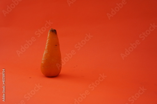 Close up of fresh mini carrots isolated on orange background, Clipping path. tuber plant. Suitable for food business, vegetables, websites, news, health care.