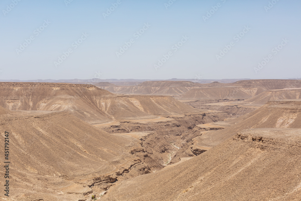 blue sky and vast dirt valley landscape like mars of hadramaut, yemen blue sky and vast dirt valley landscape like mars of hadramaut, yemen