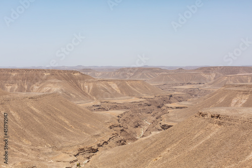 blue sky and vast dirt valley landscape like mars of hadramaut, yemen