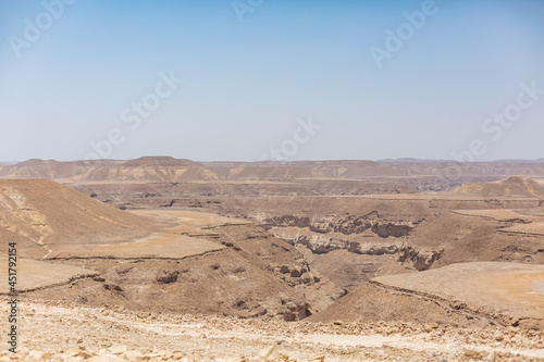 blue sky and vast dirt valley landscape like mars of hadramaut, yemen