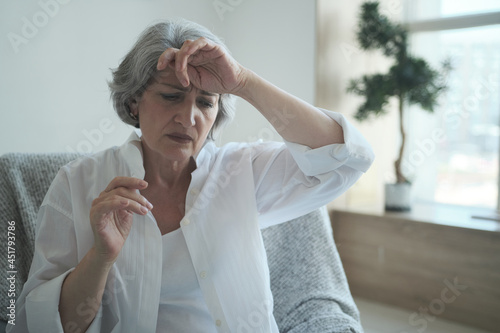 Foto Pensive sad senior middle aged grandma worried depressed lonely at home from anxiety and solitude