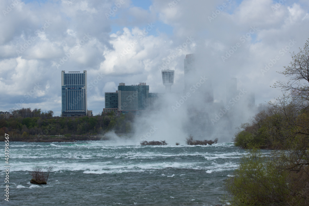 Niagara Falls Mist rising before Canada Buildings