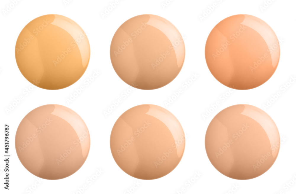 Set with different shades of liquid skin foundation on white background, top view Set with different shades of liquid skin foundation on white background, top view