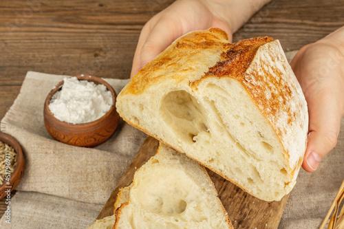 Male hands are holding freshly baked bread