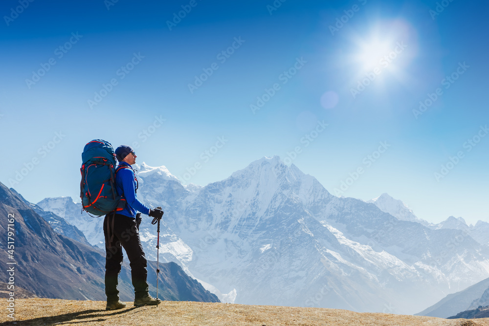 Active hiker hiking, enjoying the view, looking at Himalaya mountains landscape. Travel sport lifestyle concept