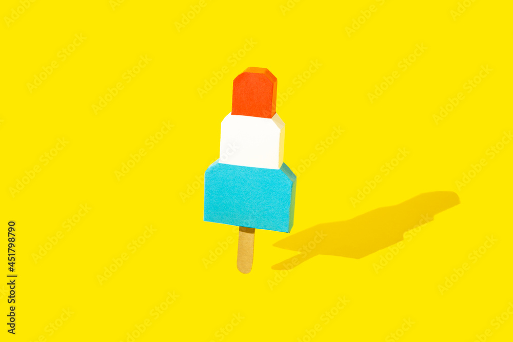 Multicolored ice cream of paper on yellow background. Multicolored ice cream of paper on yellow background.