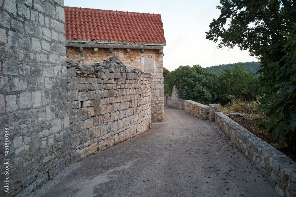 Old brick house wall and walking path. Medieval City in Croatia 