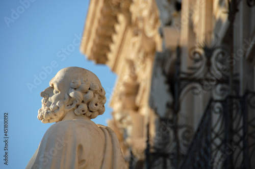Syracuse is a city in Sicily. Here is the statue of St. Peter in front of the cathedral and the town hall in Duomo  square in the peninsula of Ortigia which is the ancient center.  photo