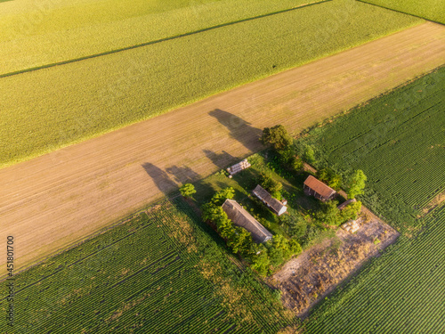 Obraz na płótnie Aerial flight over Ranch in late summer sunset in agricultural fields, Vojvodina landscape