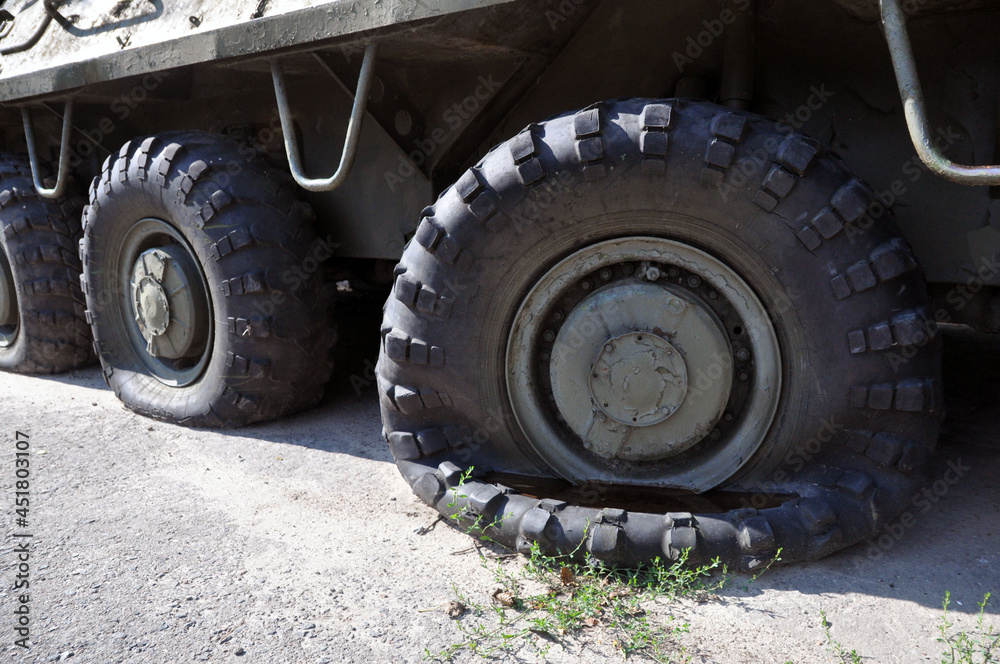 A flat tire on a voyengoy vehicle. Military padded Soviet armored personnel carrier