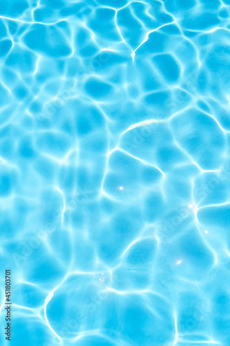 Blue water in the pool under the sun. Close-up