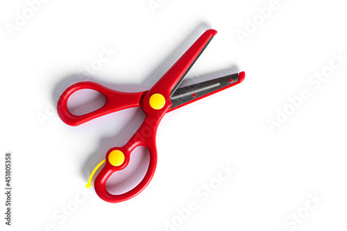 Red stationery scissors isolated on a white background.