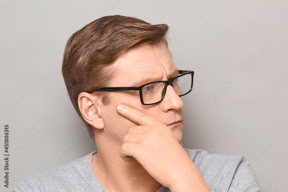 Portrait of serious thoughtful blond mature man with glasses