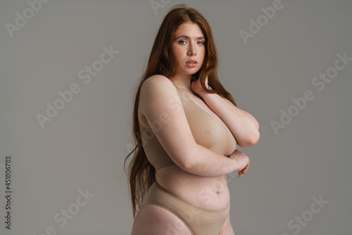 Young white plus size woman in lingerie posing