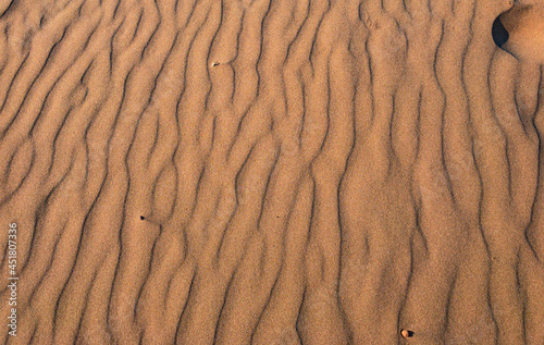 Ripples in the red sands of Green Gable Shores at sunset