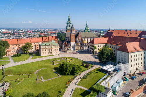 Royal Wawel Gothic Cathedral in Cracow, Poland, with Renaissance Sigismund Chapel with golden dome, a courtyard, park and tourists. Aerial view in summer