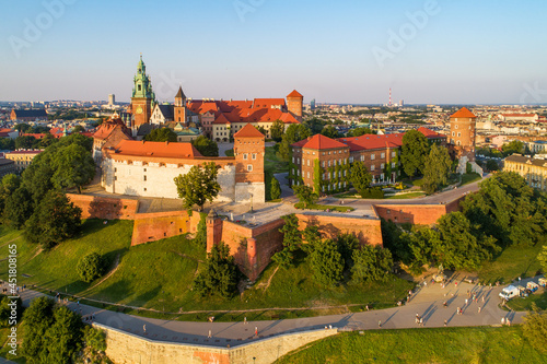 Krakow, Poland. Historic royal Wawel castle and cathedral. Aerial view at sunset in summer. Park, promenades and walking people