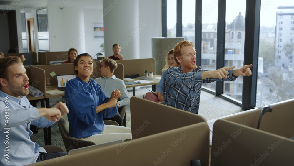 Fototapeta premium Business people celebrating success during work. Colleagues giving high five 