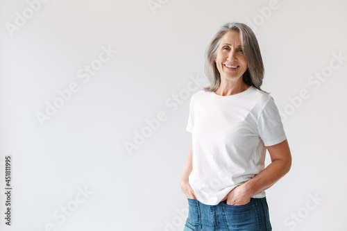 Fotografija Grey senior woman in t-shirt smiling and looking at camera