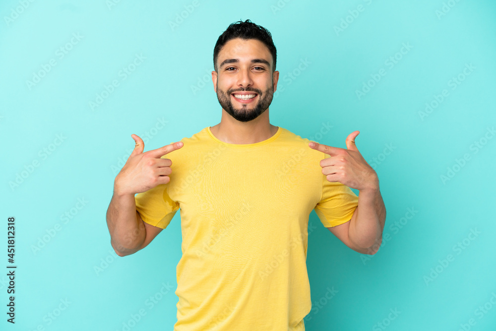 Young arab man isolated on blue background giving a thumbs up gesture Young arab man isolated on blue background giving a thumbs up gesture
