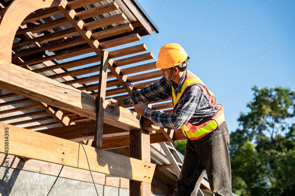 Roofer, A carpenter working on roof structure on construction site