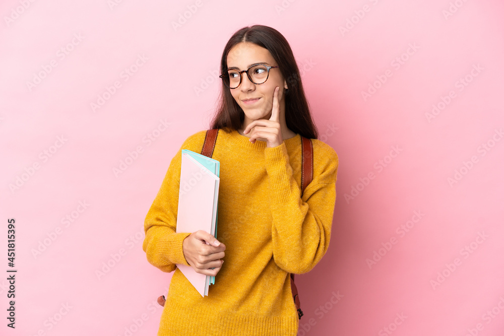 Young student woman over isolated background thinking an idea while looking up Young student woman over isolated background thinking an idea while looking up