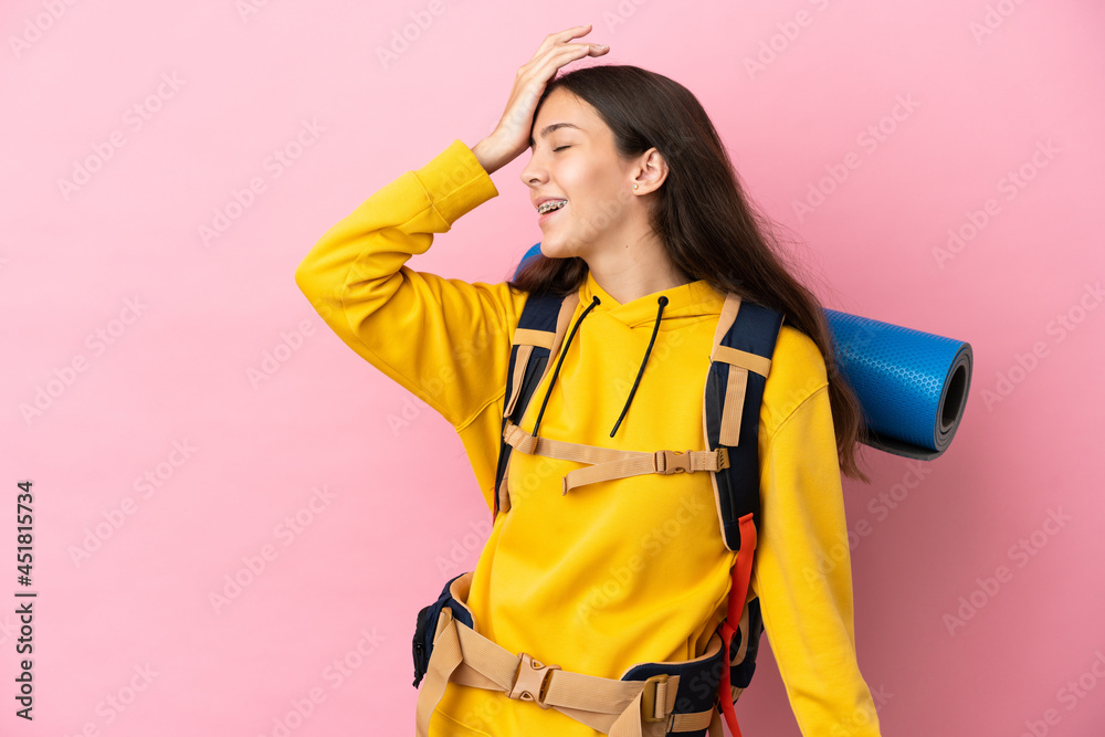 Young mountaineer girl with a big backpack isolated on pink background has realized something and intending the solution Young mountaineer girl with a big backpack isolated on pink background has realized something and intending the solution