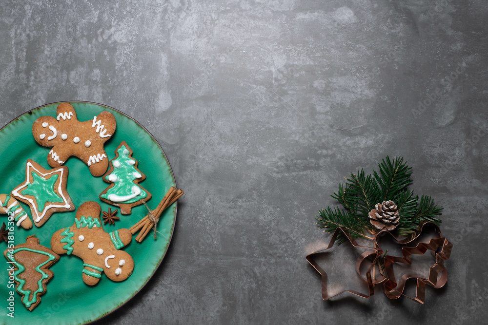 glased traditional Christmas biscuits: ginger bread man, star, christmas tree on a  plate with  anisette starts