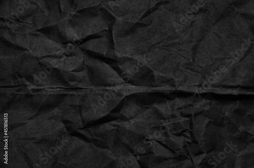 Crumpled black paper for background usage