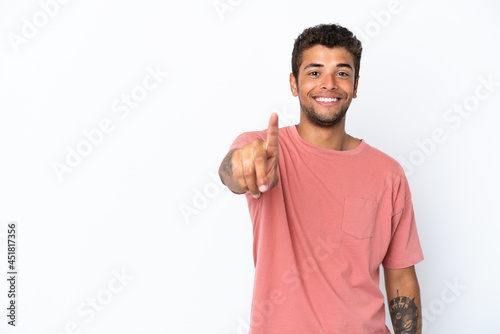 Young handsome Brazilian man isolated on white background showing and lifting a finger