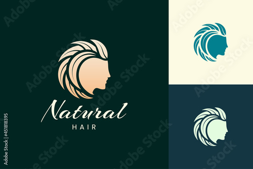 Hairdresser logo with head and leaf hair for salon and beauty brand