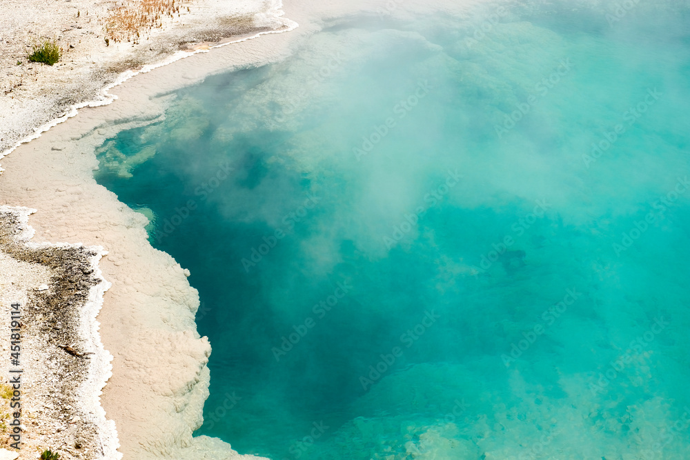 Bright Blue Turquoise Crystal Clear Hot Spring in Yellowstone National Park, Wyoming, USA Bright Blue Turquoise Crystal Clear Hot Spring in Yellowstone National Park, Wyoming, USA