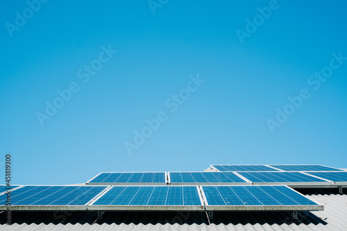 horizontal shot of solar panels with blue sky in the background photo