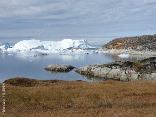 Overwhelming view of the Kanga Icefjord near the former Inuit settlement Sermermiut near Ilulissat, Greenland, on the right in the picture the transition to the open sea with the ice barrier photo