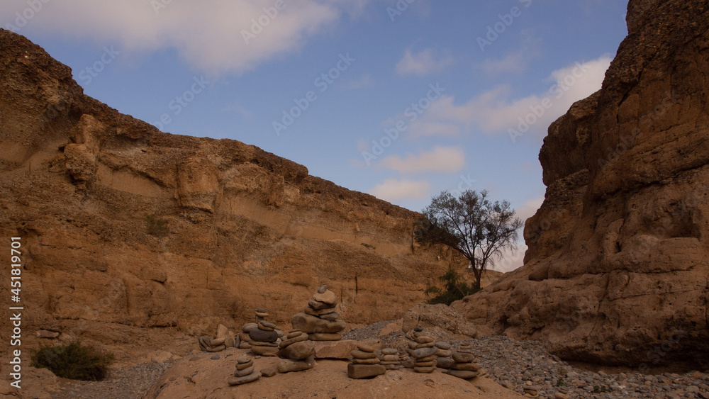 Rock cairns packed on a rock in the riverbed of the Sesriem Canyon, a popular hiking trail at Sesriem, Namibia