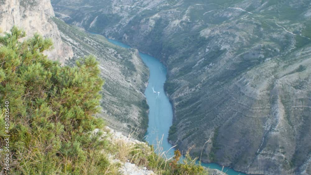 A top view of the river bend in the canyon. Speedboats are moving along the river to meet each other. Sunset time. Travel Concept A top view of the river bend in the canyon. Speedboats are moving along the river to meet each other. Sunset time. Travel Concept