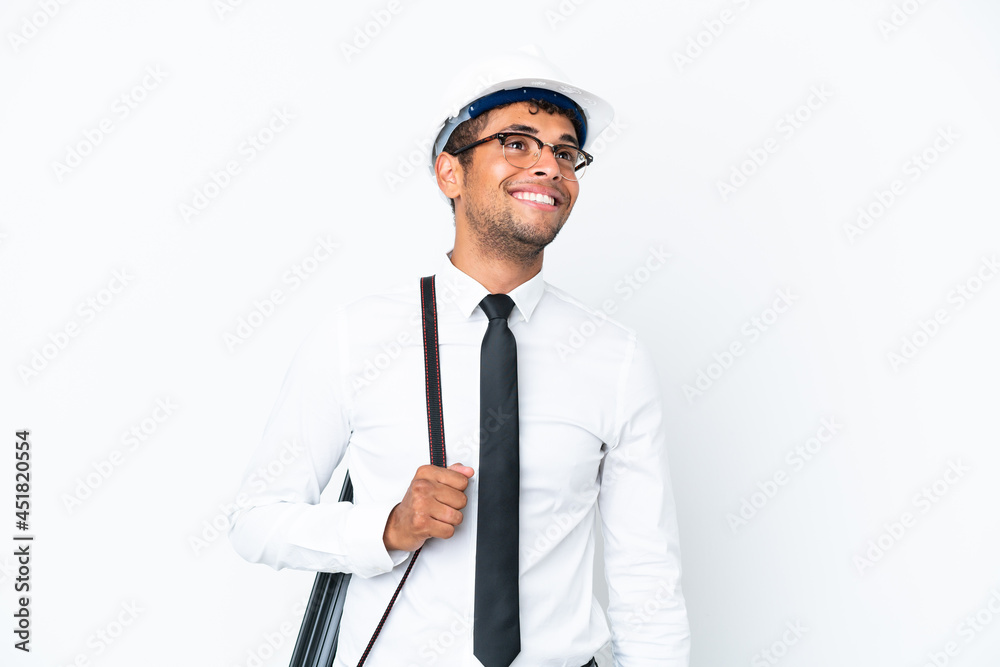 Architect brazilian man with helmet and holding blueprints thinking an idea while looking up Architect brazilian man with helmet and holding blueprints thinking an idea while looking up