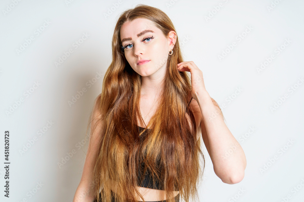 Portrait of young beautiful and cheerful girl looking at camera over white background. Portrait of young beautiful and cheerful girl looking at camera over white background.