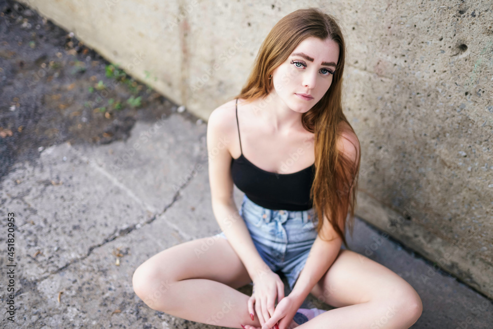 Nice and cool teen girl standing portrait on concreate place