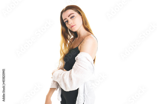 Portrait of young beautiful and cheerful girl looking at camera over white background.