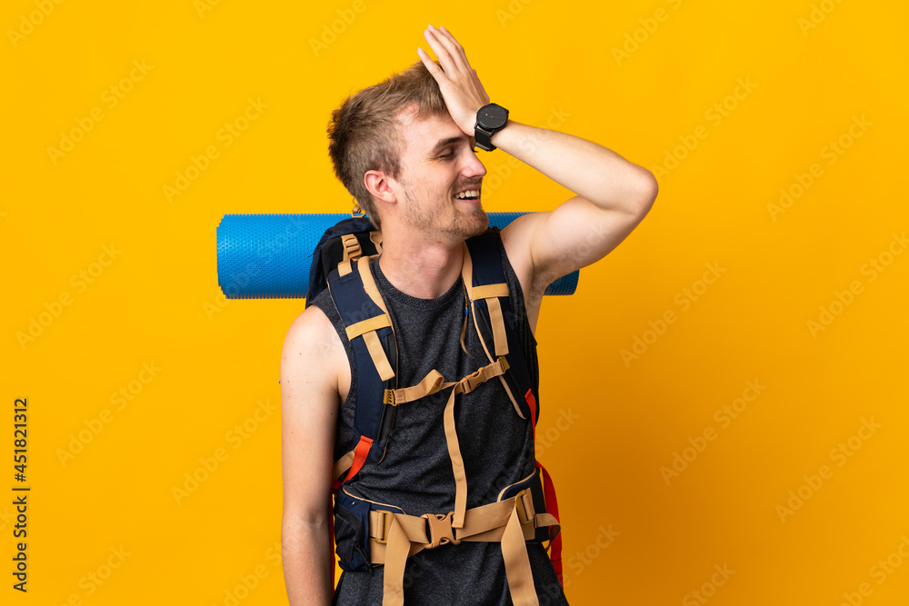Young mountaineer man with a big backpack isolated on yellow background has realized something and intending the solution Young mountaineer man with a big backpack isolated on yellow background has realized something and intending the solution