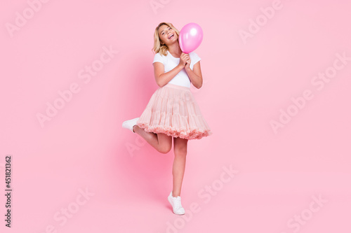 Full length photo of young excited girl happy positive smile air balloon party holiday isolated over pink color background
