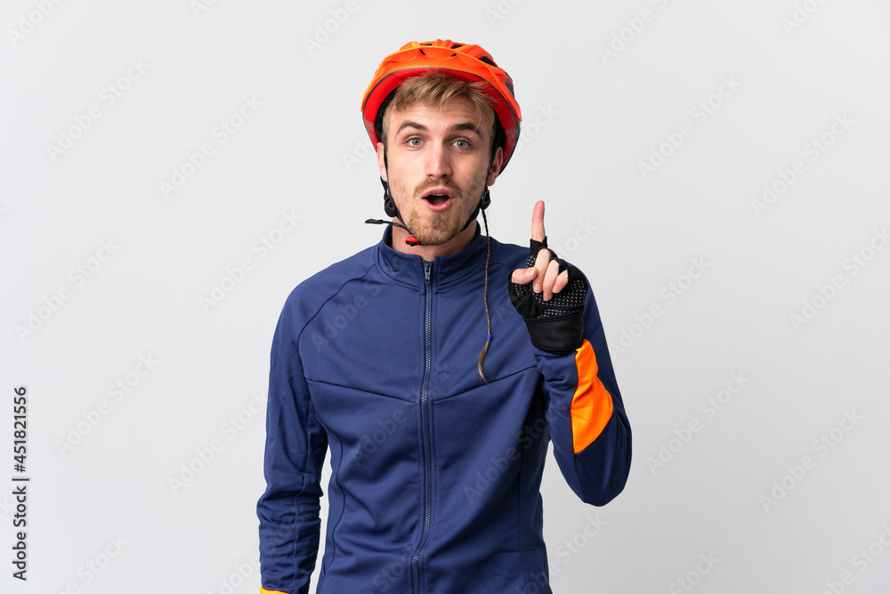 Young cyclist blonde man isolated on white background intending to realizes the solution while lifting a finger up