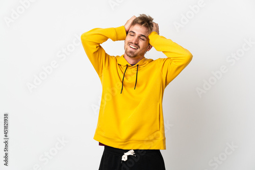 Young handsome man isolated on white background laughing © luismolinero