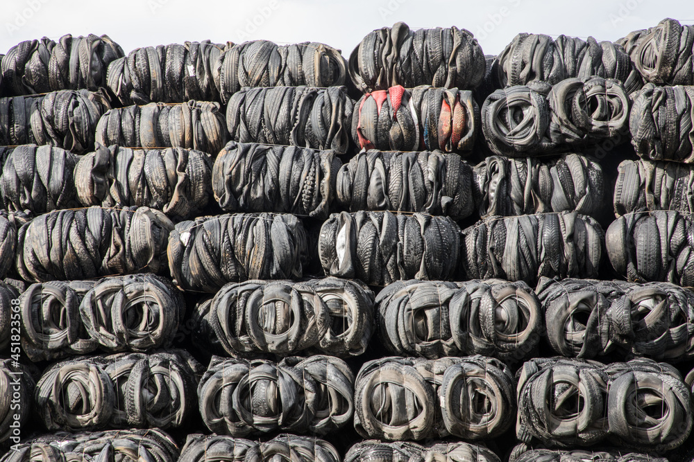 Close up shot of packed and compacted piles of old tires waiting for the  recycling in the processing  plant